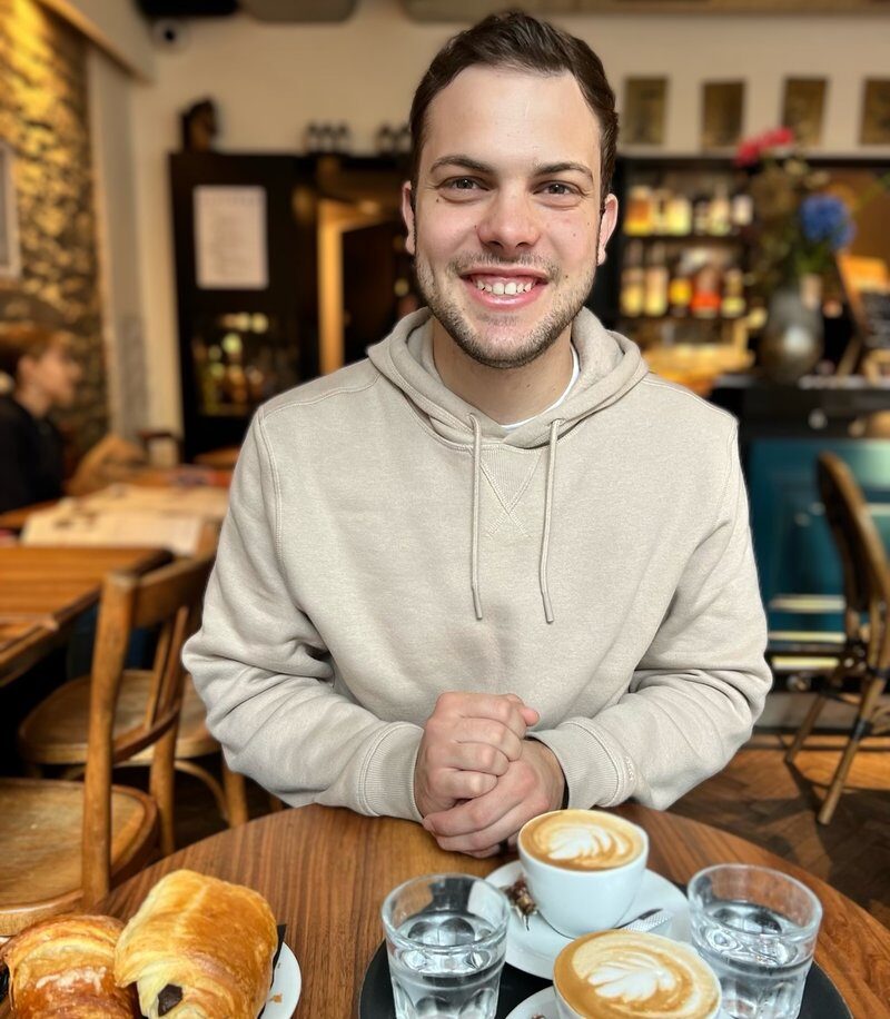 Joan Llompart smiling at a cafe table